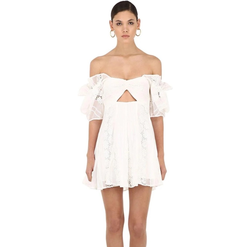 White cut out dress with ruffle off the shoulder